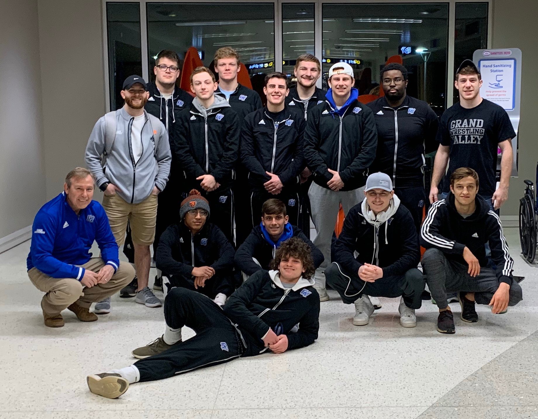 Wrestlers pose before boarding a plane to head to Dallas, Texas for National Championship tournament.
